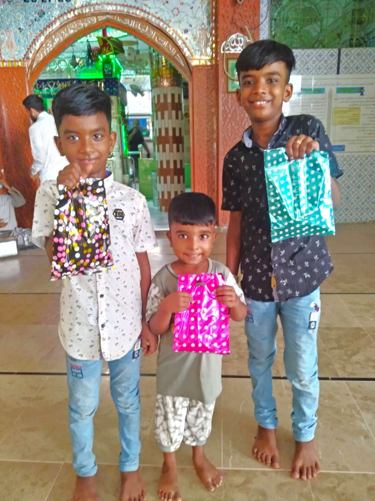 Karachi, Pakistan - Participating in Mobile Food Rescue Program by Distributing Goodie Bags Filled with Snacks, Chocolates & Candies to 60+ Less Privileged Children & Women at Local Community's Holy Shrine